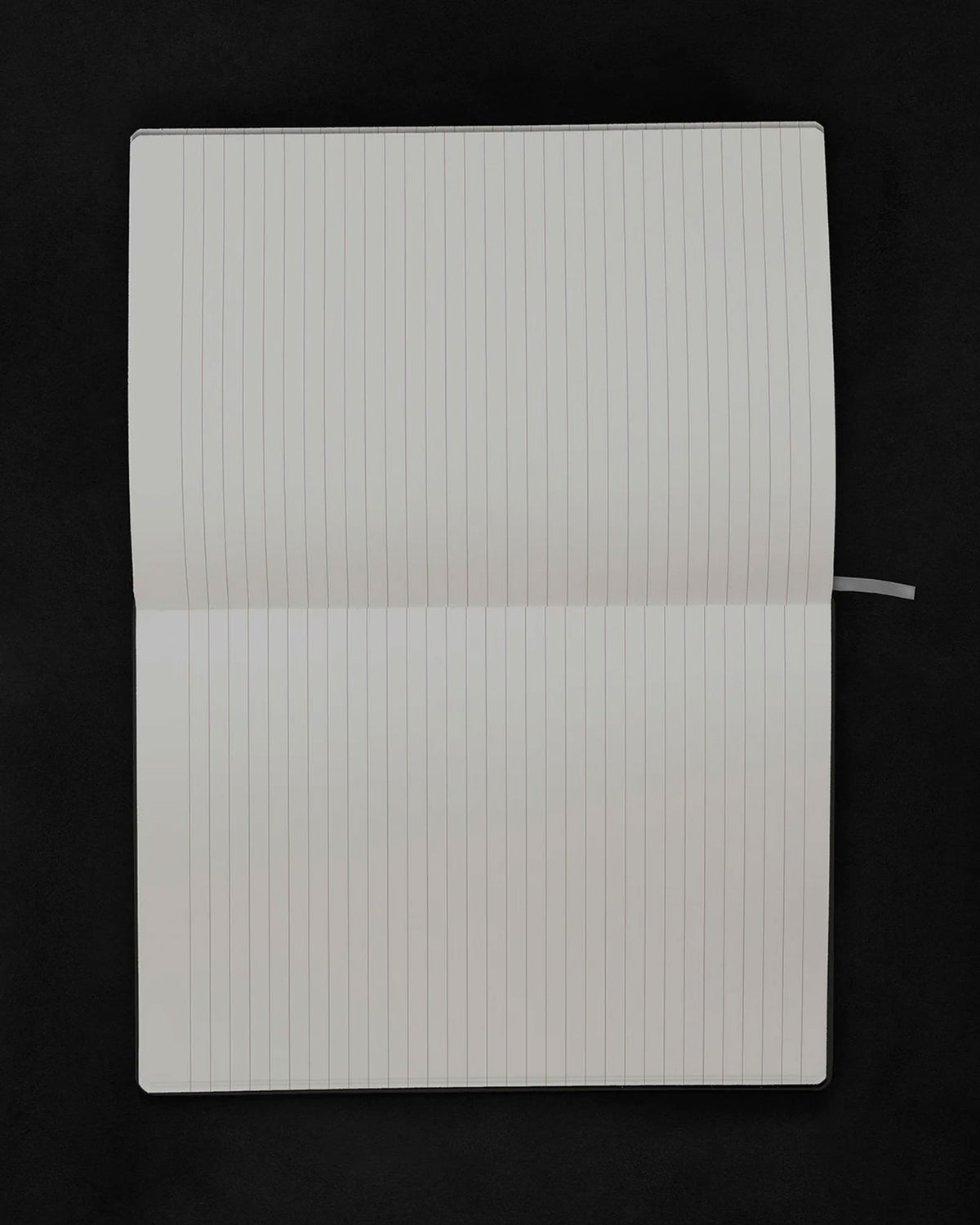 An open lined notebook with blank white pages, photographed from above against a solid black background.