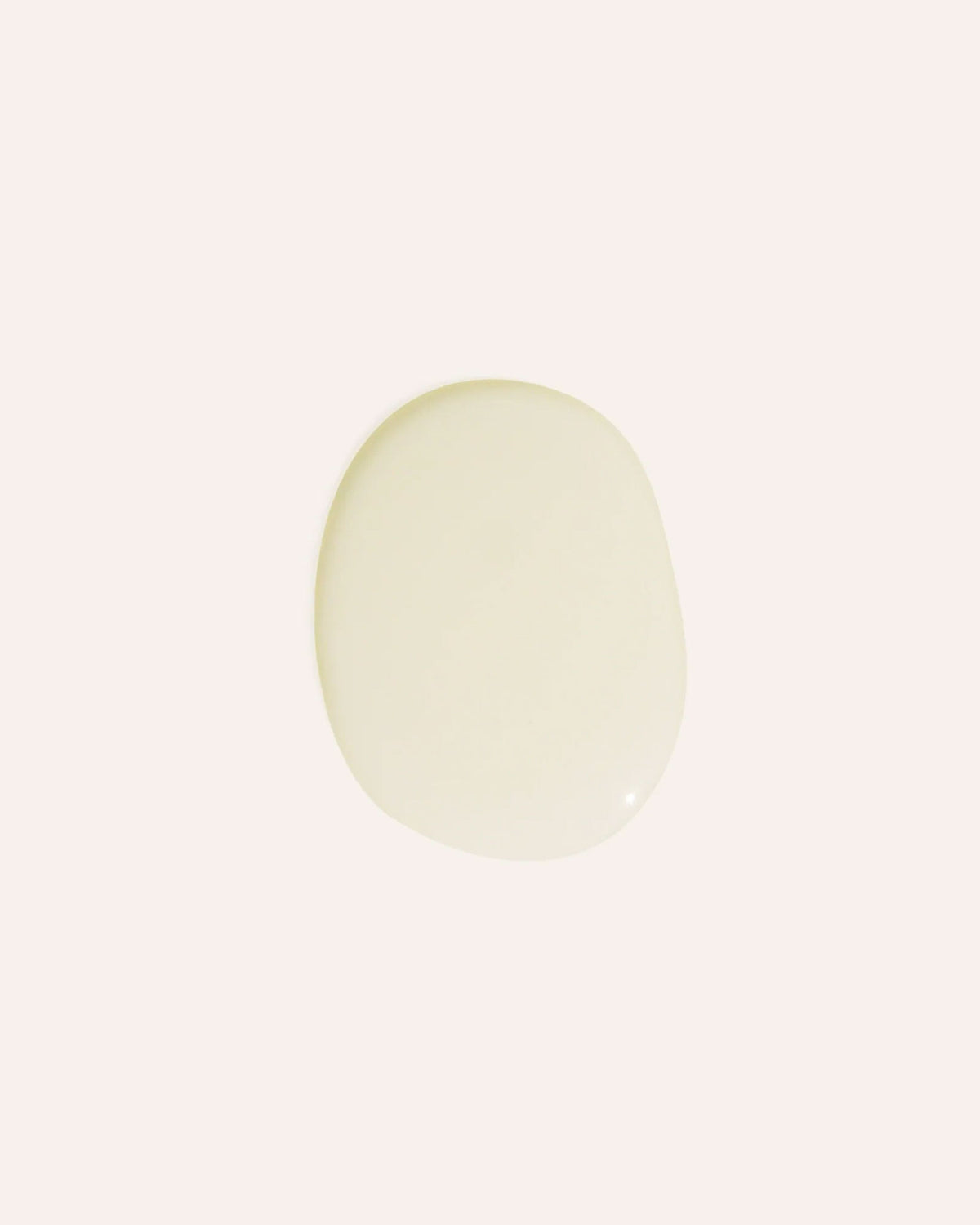 Transparent oil droplet on an off-white background.