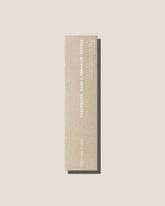 A stone coloured long, slim rectangular cardboard package with white type which reads Addition Studio CEDARWOOD, SAGE AND GERANIUM INCENSE, set on an off-white background.