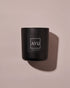 A matte black candle jar with a minimalist black label with white lettering reading &