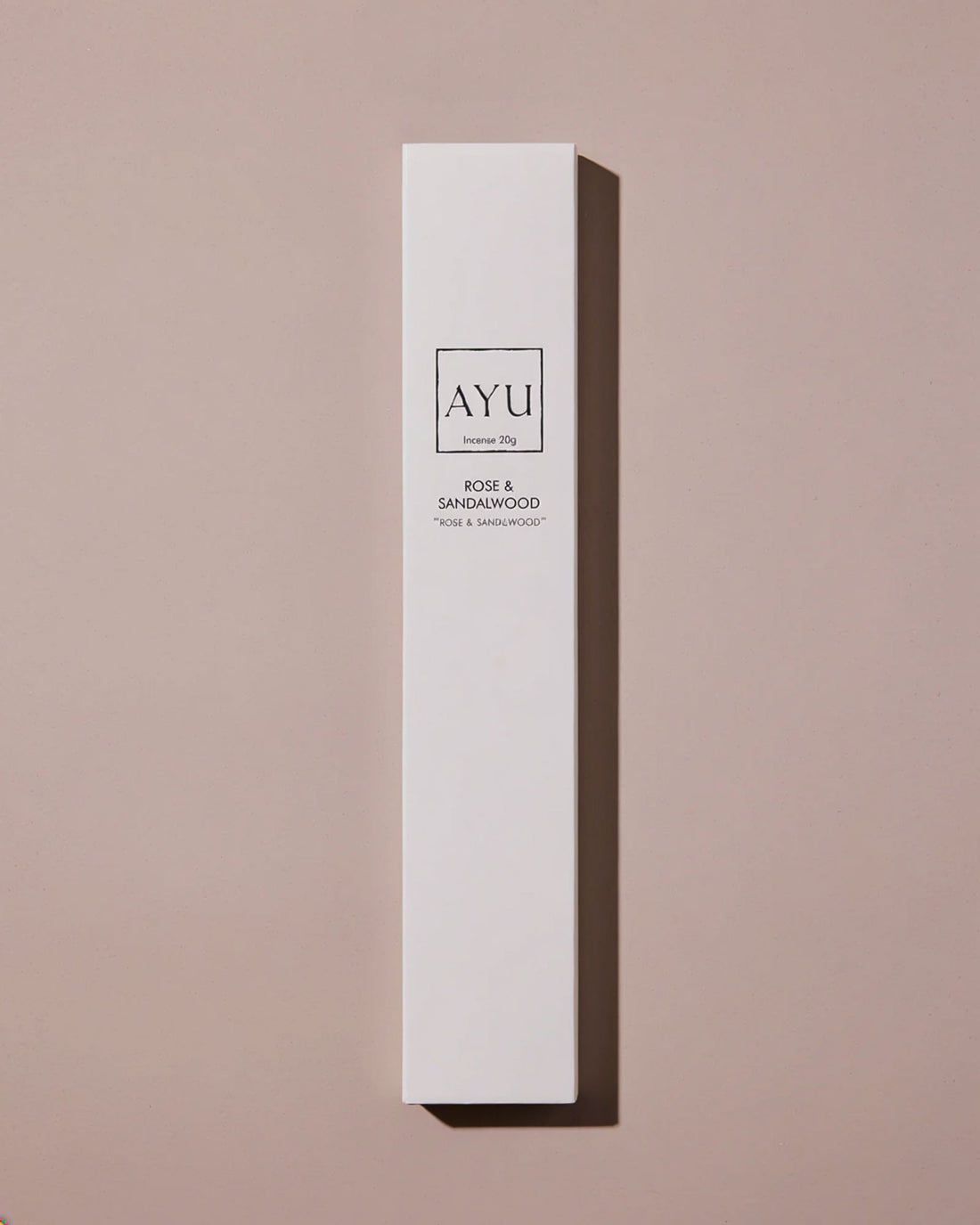 A tall, narrow white rectangular box of AYU incense, labeled &