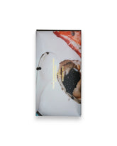 A rectangular packaged bar of Casa Bosques chocolate against a solid white background, label reads "CASA BOSQUES SEA SALT 74%" The graphic on packaging is a full bleed photo of a plate with caviar and lobster claw.