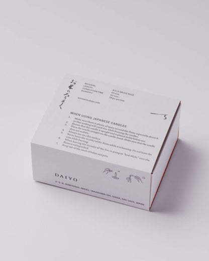 A white product box with Japanese characters and candle burning instructions printed in black ink.