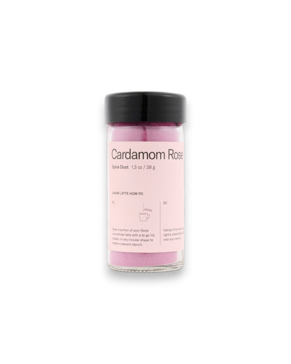 A small clear glass jar of pink powder with a black lid and a light pink label reading &