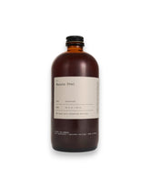 An amber glass bottle of Dona&