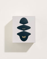 A square white box with a black abstract pattern with gold foil lettering which reads Boronia Leif. Set on a white background.