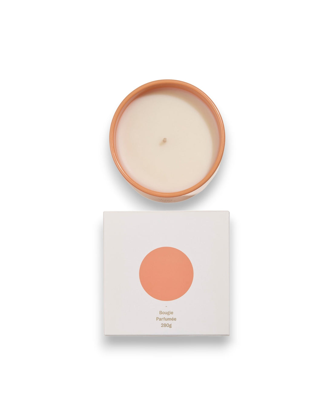 Birdseye view of a round unlit candle next to its square box that features a white lid with a peach coloured circle corresponding to the same colour of the candle container. The box reads Bougie Perfumee 280g, set on an all white background.