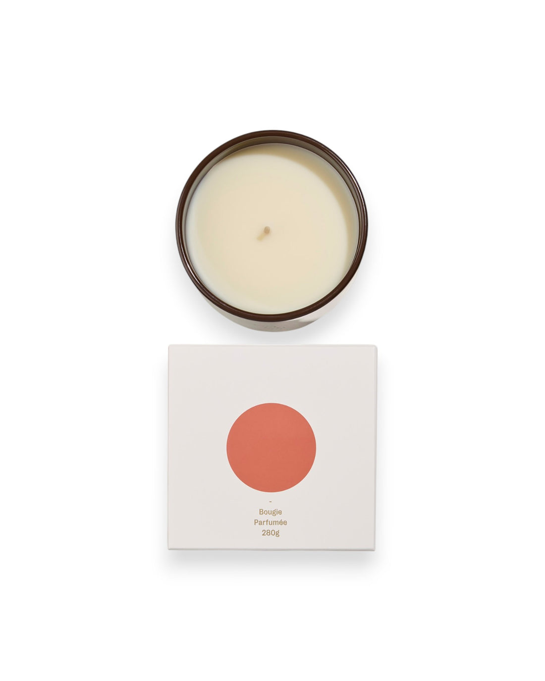 Birdseye view of a round unlit candle next to its square box that features a white lid with an orange coloured circle. The box reads Bougie Perfumee 280g, set on an all white background.