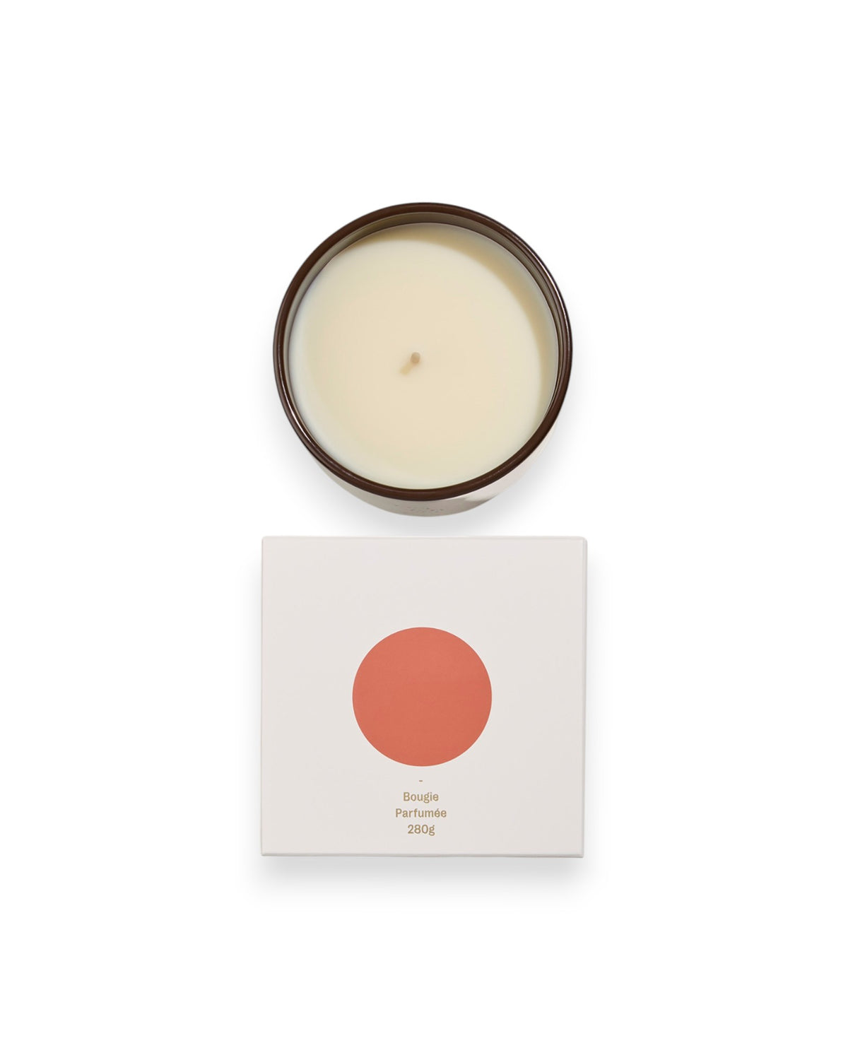 Birdseye view of a round unlit candle next to its square box that features a white lid with an orange coloured circle. The box reads Bougie Perfumee 280g, set on an all white background.
