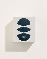 A square white box with a black abstract pattern with gold foil lettering which reads Flannel Flower Leif. Set on a white background.