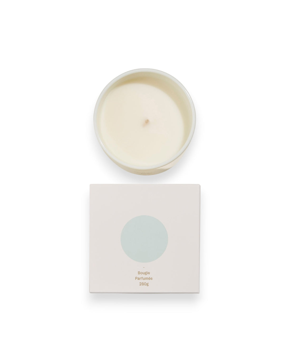 Birdseye view of a round unlit candle next to its square box that features a white lid with a baby blue coloured circle. The box reads Bougie Perfumee 280g, set on an all white background.