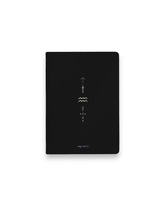 A black hardcover notebook featuring the Aquarius zodiac sign and its chart symbols printed in metallic on the front cover, set against a clean white background.