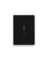 A black hardcover notebook featuring the Taurus zodiac sign and its chart symbols printed in metallic on the front cover, set against a clean white background.