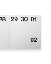 A close-up of a white calendar or planner page showing numbered days 28, 29, 30, 01 and 02 in black text, on a white background.