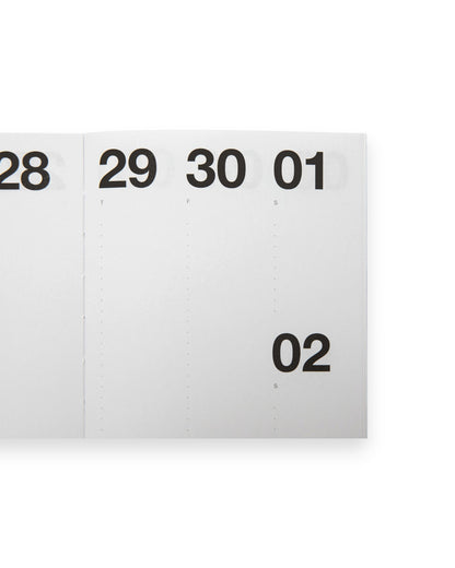 A close-up of a white calendar or planner page showing numbered days 28, 29, 30, 01 and 02 in black text, on a white background.