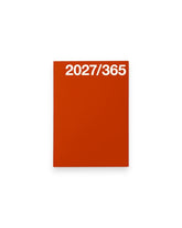A rectangular A6 red planner cover with the white text &