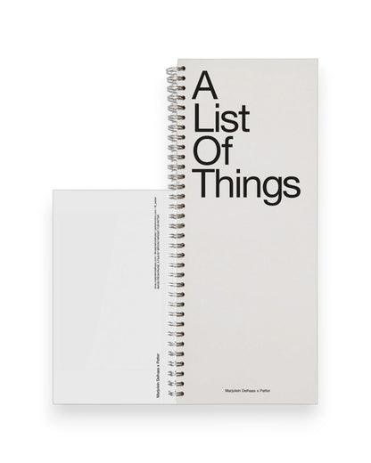 A tall ledger style notebook with wire binding, cover reads in large black letters A List Of Things. Set on a solid white background.