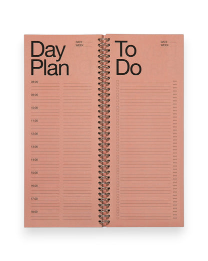 An open spread of a tall, rectangular ring-bound planner with pink pages. Set on a solid white background. 