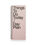 Tall, rectangular, light pink ring-bound planner with large, bold black letters which read Things To Do Today / Day Plan on a solid white background. 