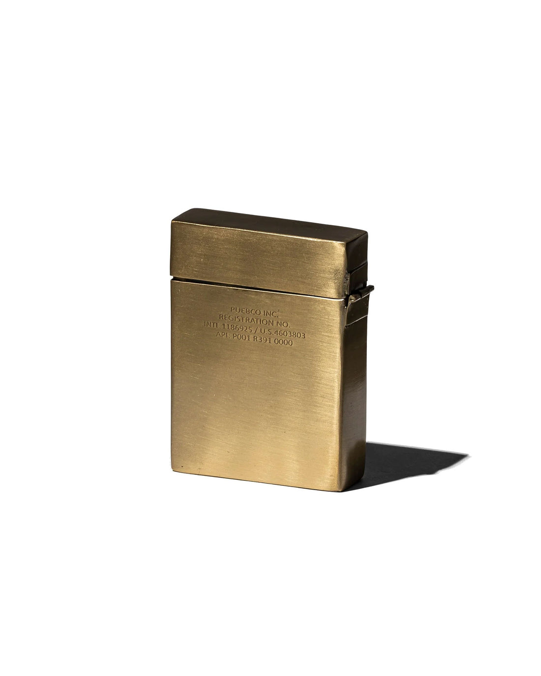 A rectangular brass card case with a brushed satin finish on a light grey background. 