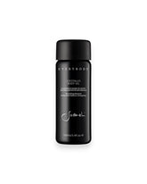 A black, cylindrical, glass bottle of Sodashis&
