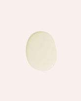 Transparent oil droplet on an off-white background.