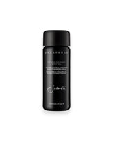 A black cylindrical, glass bottle of Sodashi&