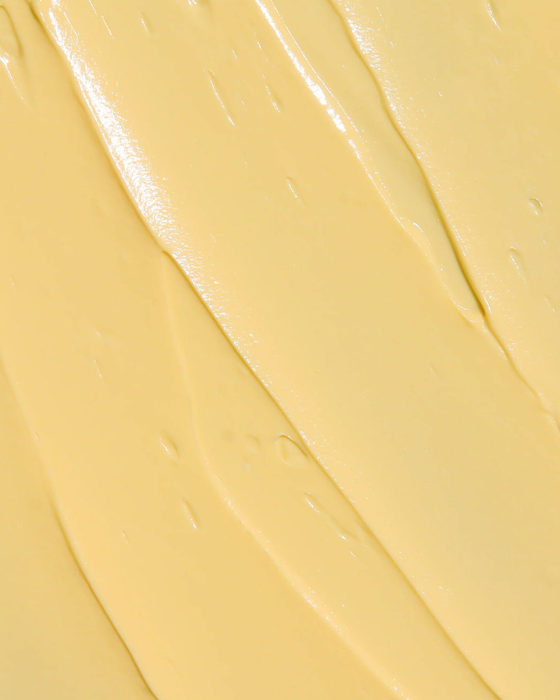 Close-up of a butter-coloured cream texture.