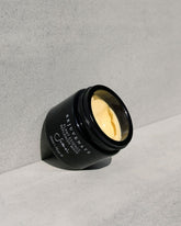 A black glass jar of Sodashi&