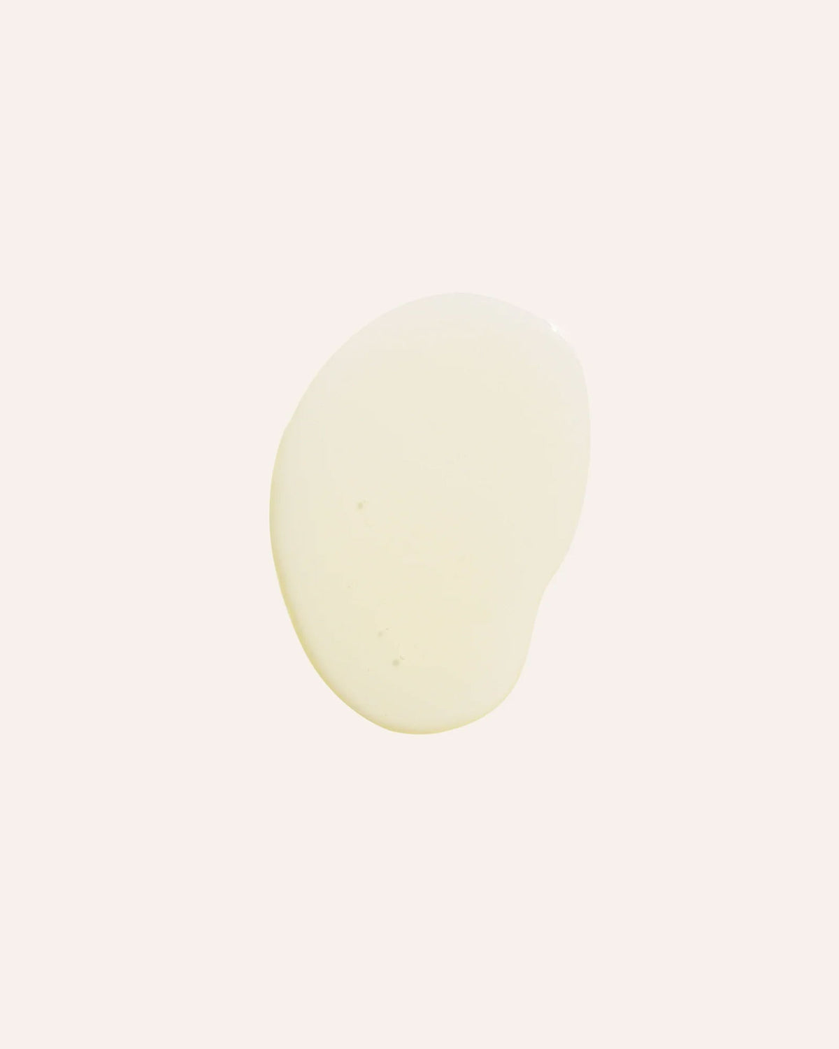 A circle of light yellow, translucent oil on an off-white background.
