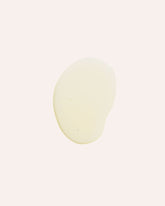 A circle of light yellow, translucent oil on an off-white background.