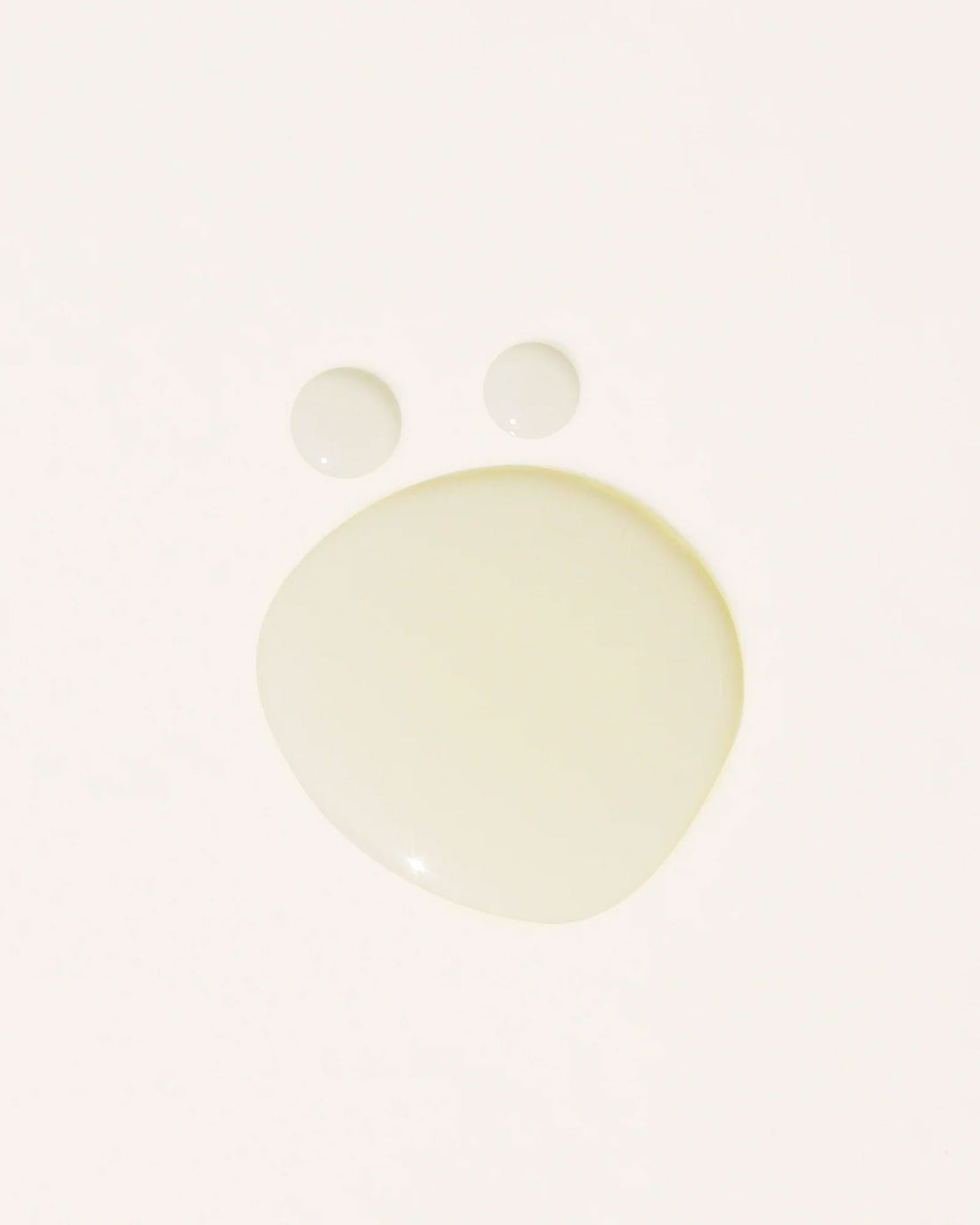 Transparent oil droplets on an off-white background.
