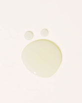 Transparent oil droplets on an off-white background.