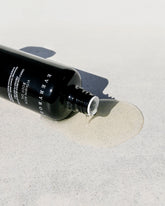 A black glass bottle of Sodashi&