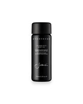 A black cylindrical glass bottle of Sodashi&