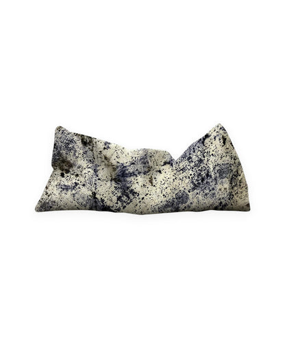 A rectangular weighted eye pillow in beige with purple abstract speckled patterns, shown on a plain white background.