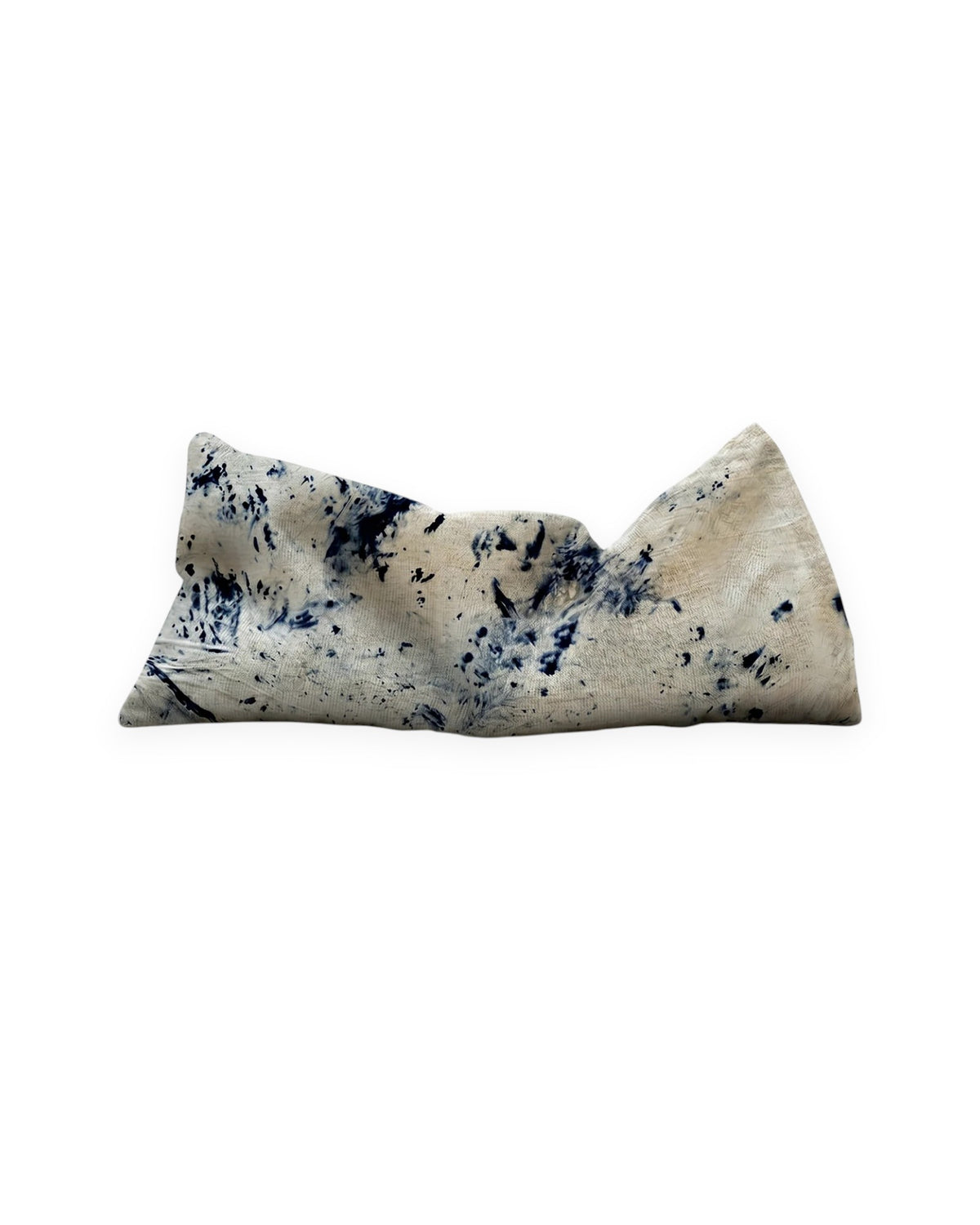 A rectangular weighted eye pillow in beige with dark navy blue abstract speckled patterns, shown on a plain white background.