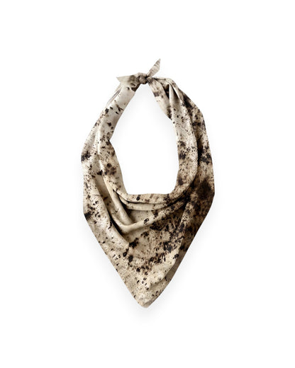 A brown and cream mottled silk scarf tied as a traditional neck scarf on solid white background.