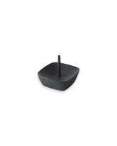 Product shot of a black iron candle stand with a square design and a central pin.
