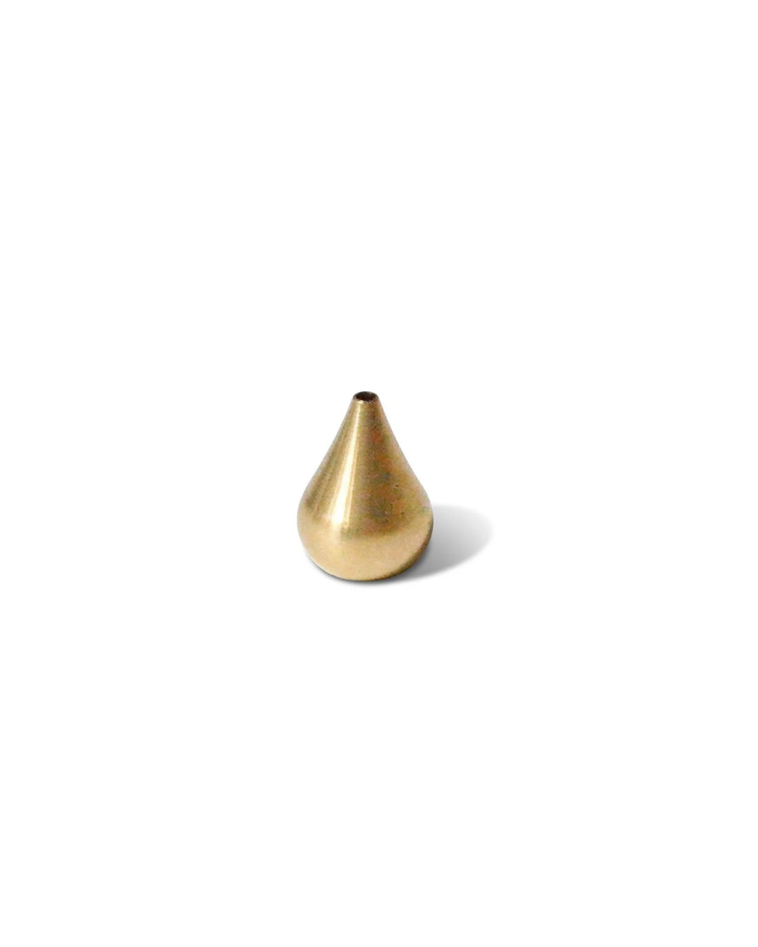 A small teardrop shaped brass incense holder on a solid white background. 
