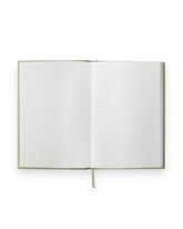 The inside spread of a Wilde House Paper moss-coloured, hardcover journal showing plain lined pages, photographed on a solid white background. 