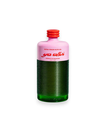A bottle of Palestinian extra virgin olive oil with a pink upper label, a ribbed dark green bottle body, and a red cap, shown on a white background.